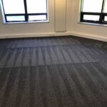 This is a photo of a grey office carpet that has just been professionally steam cleaned works carried out by Clerkenwell Carpet Cleaning