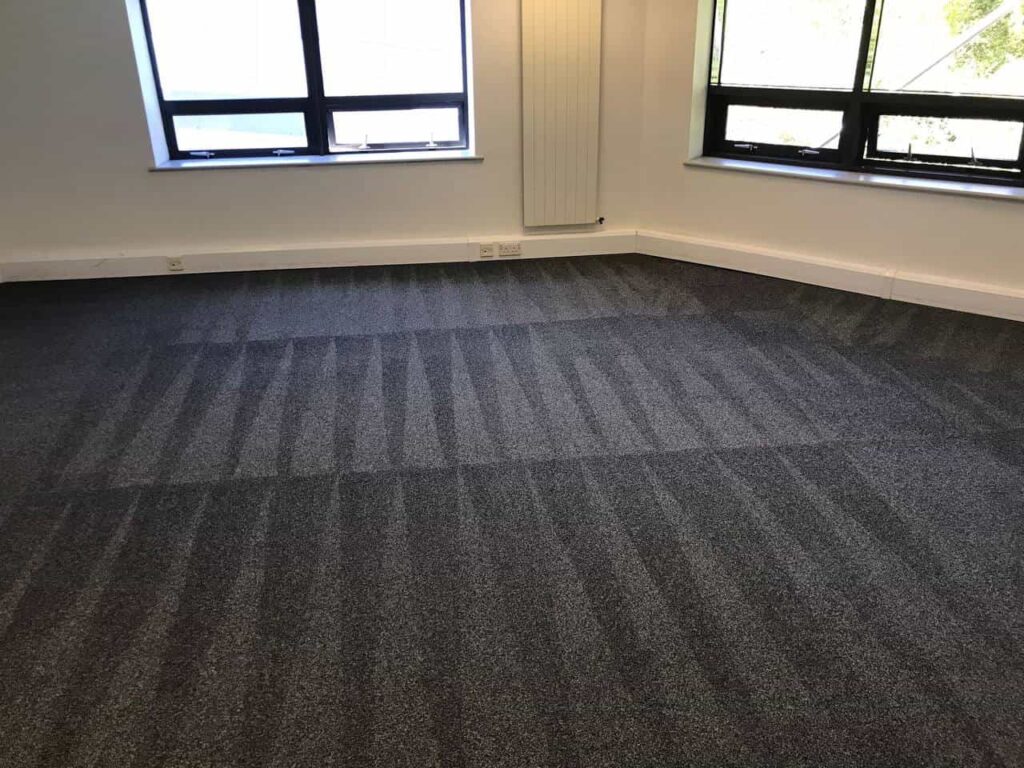 This is a photo of a grey office carpet that has just been professionally steam cleaned works carried out by Clerkenwell Carpet Cleaning